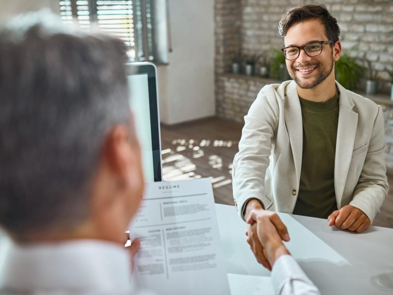 happy-male-candidate-greeting-member-human-resource-team-job-interview-office_637285-6567